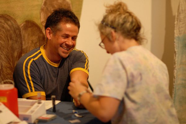 an artist gets their cholesterol checked at Springboard's Artist Health Fair