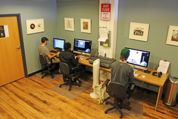 Artists working at computers in the Lowertown Resource Center.
