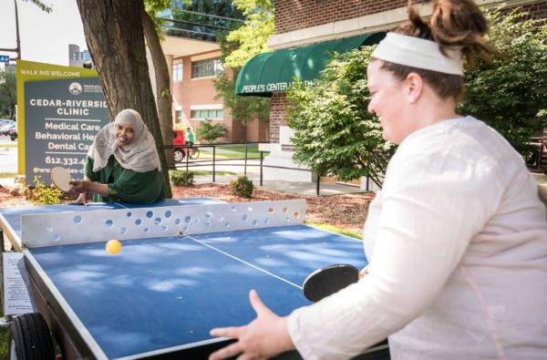 People’s Center staff playing ping pong on the Temporary Table Tennis Trailer on the clinic lawn.