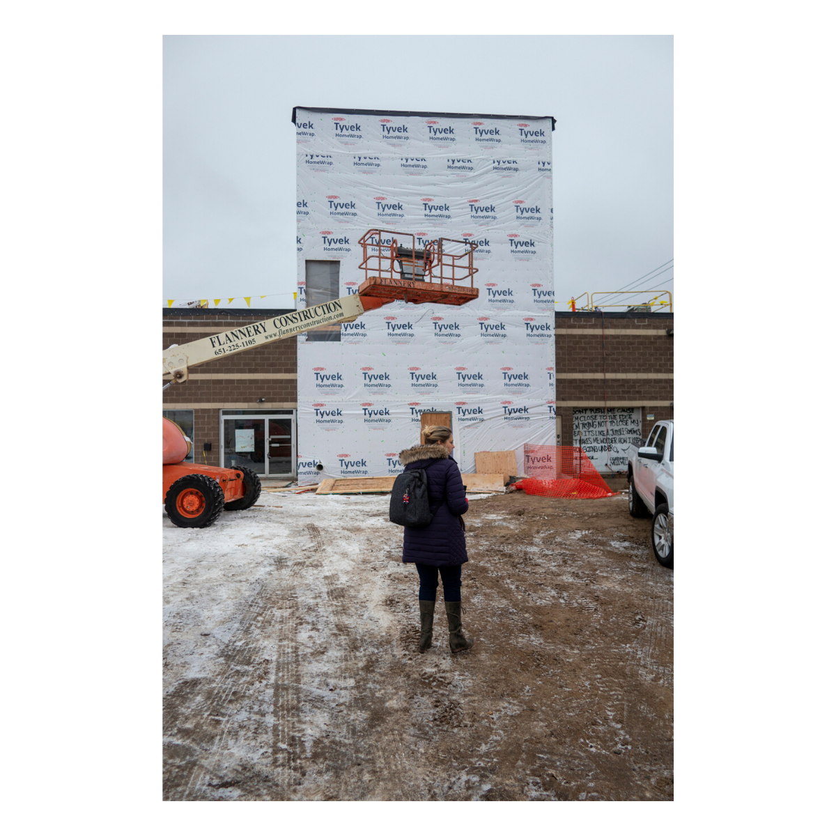A person standing outside a construction site