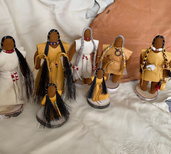A series of small dolls in Ojibwe clothing