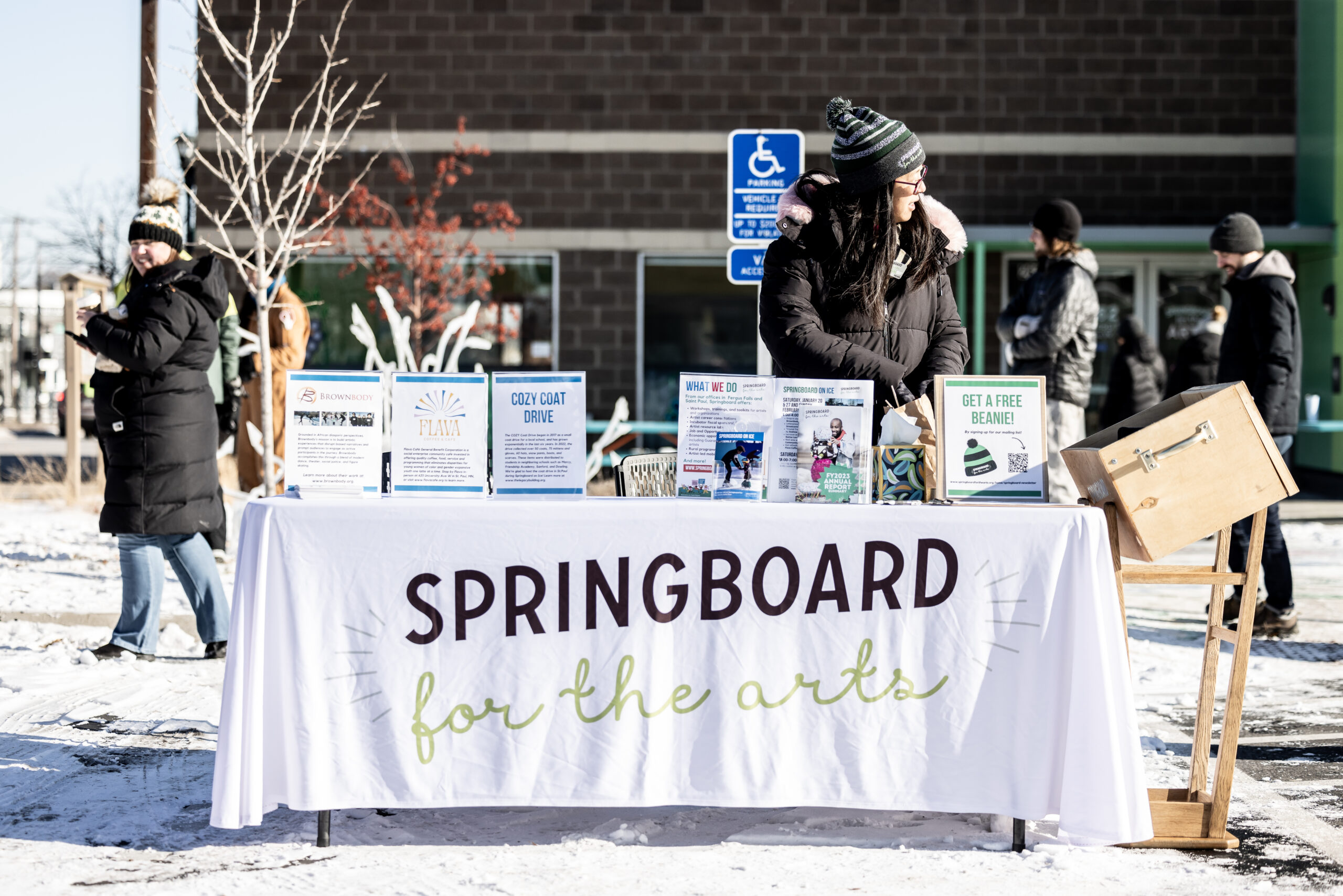 Springboard for the Arts' welcome table at Springboard on Ice, 2024.